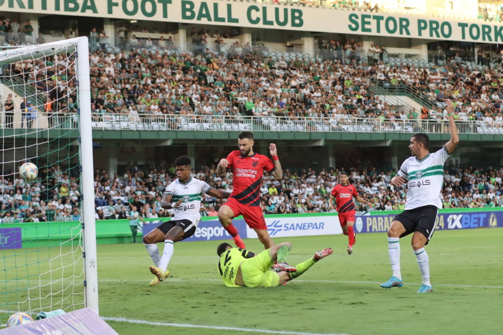 Mastriani, do Athletico, disputa a bola com o goleiro do Coritiba durante uma partida da temporada.