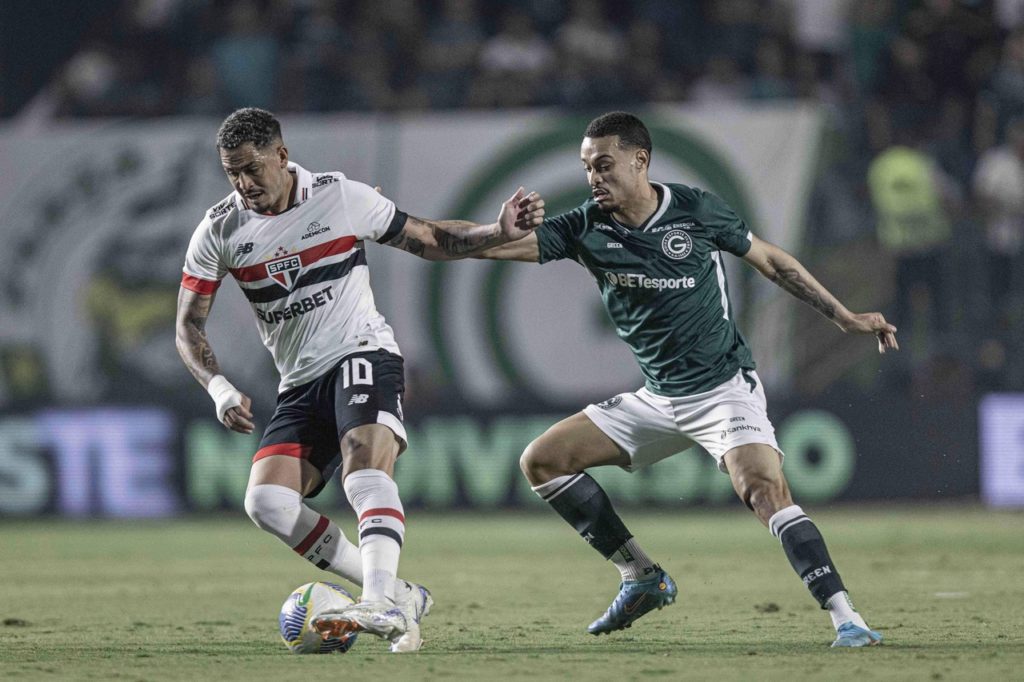 Luciano, do São Paulo, disputando a bola com um adversário em um jogo de Copa do Brasil.